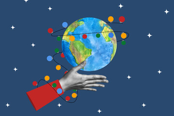 Human hand and planet Earth wrapped in festive New Year garland. Christmas concept in collage style. © Юлия Ромашко