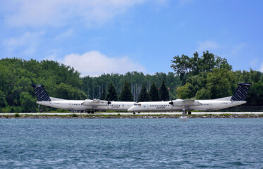 Fototapeta premium Turboprop airplanes on the runway at Toronto Billy Bishop downtown waterfront airport
