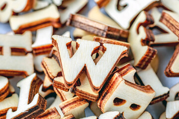 Alphabet letters on wooden block pieces, from above.Close up of Wooden letter cubes.Challenge and solution concept.Hobbies and leisure activities