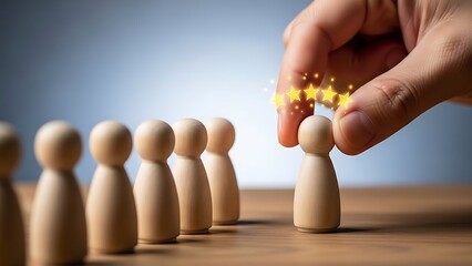 Hand selecting a wooden figure, awarding it with stars