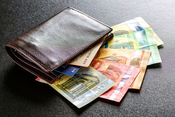 Various currencies in purse close-up.Open wallet with euro banknotes.British coins , pound sterling.Dollars cash and credit cards.Finance concept