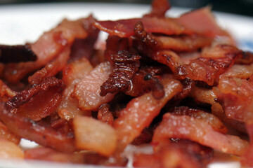 Macro close-up of a pile of crispy fried bacon pieces