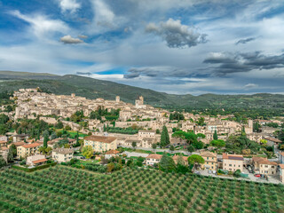 Aerial panoramic view of Assisi in Umbria, medieval town with Franciscan churches, towers, castles, city walls in Italy
