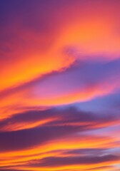 Fototapeta premium A magnificent, vibrant sunset sky is dominated by dramatic, flowing clouds painted in brilliant hues of orange, pink, purple, and glowing gold light, outdoors, purple, clouds