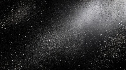 Obraz premium A visually striking image showcasing a black background adorned with shimmering silver particles. The particles create a sense of depth and movement, evoking creativity.