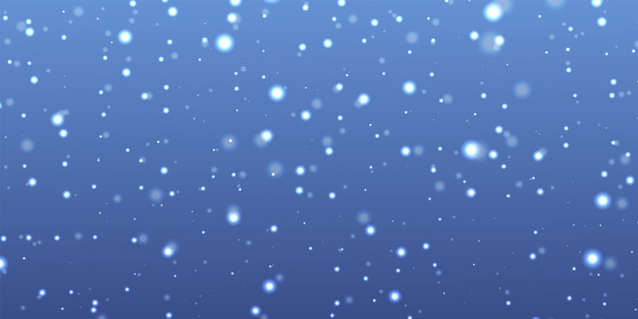 Abstract blue background with falling white bokeh light particles resembling snow or glitter