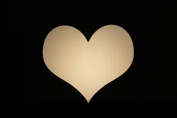 A luminous heart shape glowing against a dark, minimalist background. This simple, striking image evokes feelings of love, romance, passion, and warmth, ideal for Valentine's Day or emotional themes.