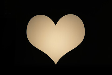A luminous, soft off-white heart shape isolated on a stark black background, symbolizing love, passion, and romance. Perfect for Valentine's Day, expressions of affection, or emotional concepts.