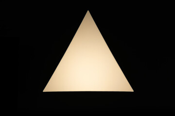 Fototapeta premium A glowing, minimalist triangle shape with warm light against a solid black background, creating a strong contrast and abstract geometric art. Ideal for concepts of direction, focus, or simplicity.