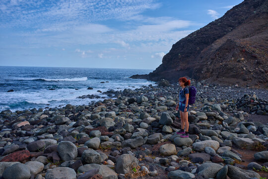 Woman hiker at Playa Tamadiste shore