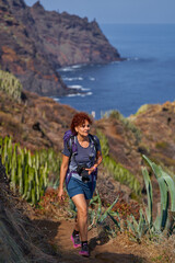 Naklejka premium Woman photographer hiking Anaga coast