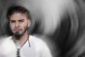 Adult male with calm expression in artistic textured background and soft motion blur.