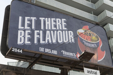 Fototapeta premium traditional roadside billboard for Tahini's, a Mediterranean restaurant, spotted near Queens Quay East (nearest location at 32 Downes St) Toronto