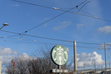 Fototapeta premium round Mermaid logo sign of Starbucks, a coffee shop chain, located here at 23 Leslie St, Toronto