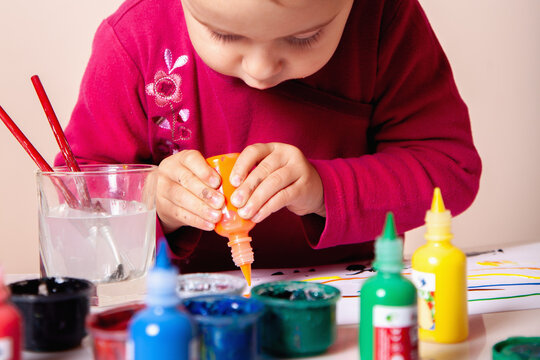 Small child deeply focused on her artistic project. - Powered by Adobe