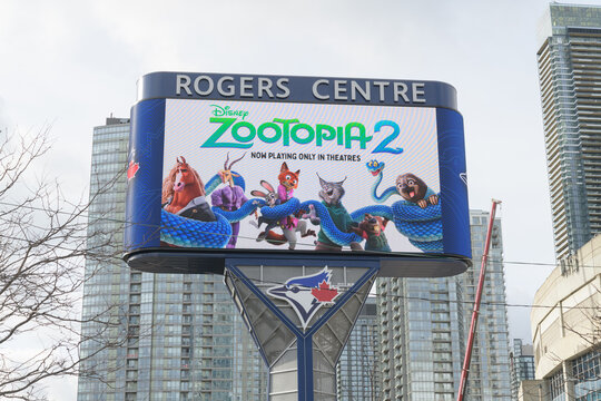 roadside digital billboard outside Rogers Centre feat movie promotion for Zootopia 2, with Blue Jays logo, Toronto