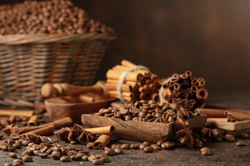 Coffee beans with spices on a brown vintage background.