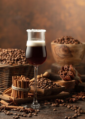 Coffee liqueur with cream on a brown background.