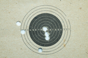 Paper shooting target with bullet holes  © balogh