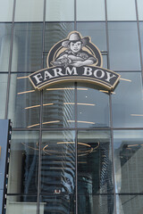 Obraz premium exterior building facade and sign of Farm Boy, a fresh food market, located here at 100 Queens Quay E, Sugar Wharf Condominiums, Toronto