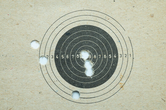 Paper shooting target with bullet holes
