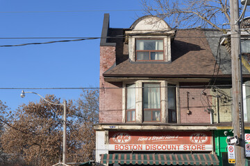 Fototapeta premium exterior building facade and sign of Boston Discount Store located at 1020 Queen St E, Toronto