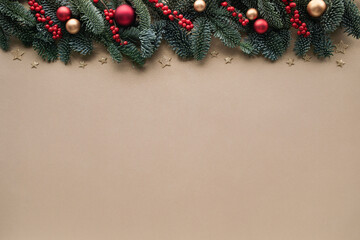 Christmas background for festive greeting card with fir branches, red berries and shiny decorations...