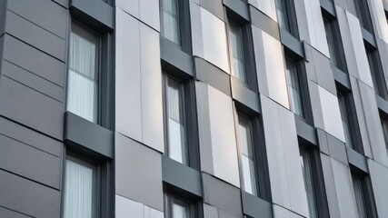 Medium shot of soundproof panels affixed to a buildings exterior illustrating architectural solutions for minimizing environmental noise pollution.