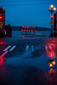 The Public Market sign and a ferry on a dark rainy evening in Seattle - January 7, 2018