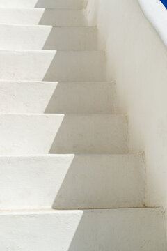 Abstract view of typical greek architecture detail of rustic outside steps to a rooftop in a white-washed sugar cube village
