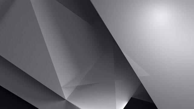Dynamic grayscale geometric relief with sharp angles and deep shadows creating a modern, abstract composition