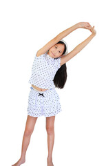 Cheerful young Asian girl in polka dot outfit smiles while performing a side stretch, warming up...