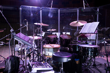 Drum kit on stage before a concert behind a screen
