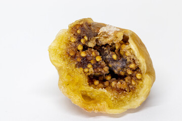 Dried figs, cut fig seeds visible. Isolated on a white background. Macro, close-up.