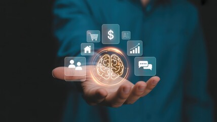 A person holding a holographic brain surrounded by business icons. It symbolizes the power of innovative thinking, strategic planning, and the connection between mind and commerce.