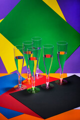 Still life with wine glasses on a colored background