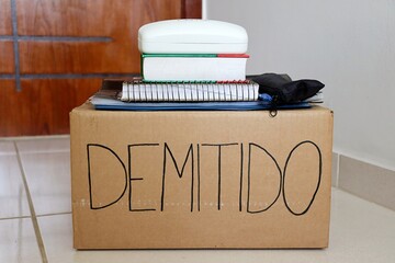 Cardboard box labeled "Demitido" (Fired in Portuguese) symbolizing job termination and layoff. 