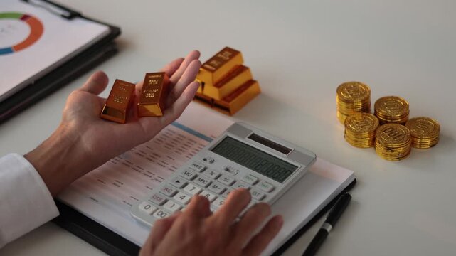 Businessman investing in gold to diversify portfolios hedge against inflation and currency depreciation.
