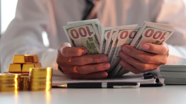 Businessman investing in gold to diversify portfolios hedge against inflation and currency depreciation.