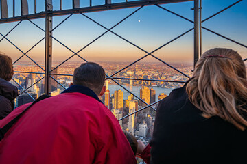 Visitors enjoy sunset views of Midtown from the Empire State