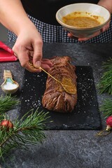 Honey mustard glaze on seared beef tenderloin for roast beef. Roasting beef whole in the oven. Merry Christmas.