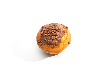 Top view of a golden muffin topped with chocolate frosting and crunchy sprinkles on a white background. Soft shadow and plenty of copy space.
