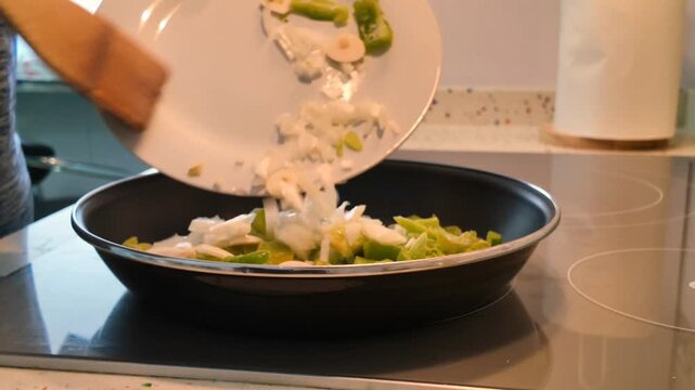 leaving the vegetables from a white plate in the pan to make the sofrito