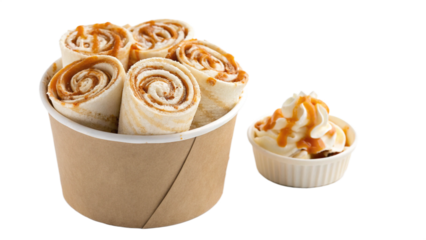 Delicious caramel ice cream rolls served in a cup, paired with a side of whipped cream and caramel sauce, offering a sweet treat experience for dessert lovers