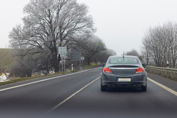 View from the driver's window of a passenger car on the road, driving in a convoy behind a car, transport and means of transport