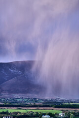 Aerial view of dramatic evening storm clouds at stunning evening in Ireland Co.Mayo, pouring rain beside mountain