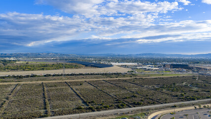 Aerial shot of homes, majestic mountain ranges and lush green foliage in Duarte California USA