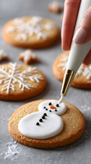 Decorating holiday snowman cookie with royal icing for christmas festive baking