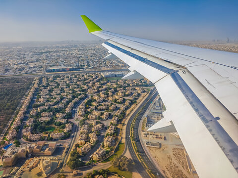 Dubai from above. Plane landing in Dubai, United Arab Emirates, Dubai view from an airplane window. - Powered by Adobe