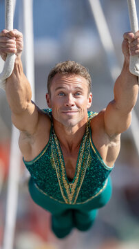 Dynamic trapeze artist in mid-swing showcasing aerial acrobatics for performance art